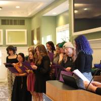 WGS Director Julia Mason reads the names of the 2023 Triota graduating members